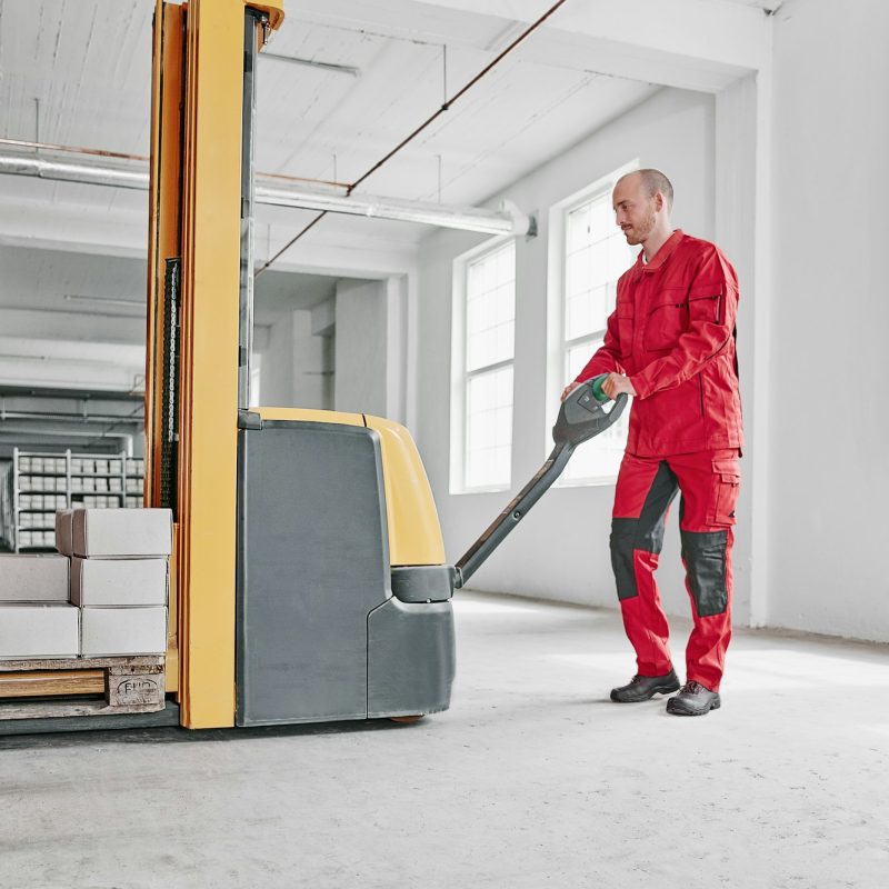 Man in factory using forklift